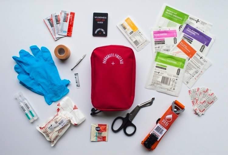 Comprehensive first aid kit contents with blister treatment, wound care supplies, bandages, and emergency supplies for Great Walks hiking