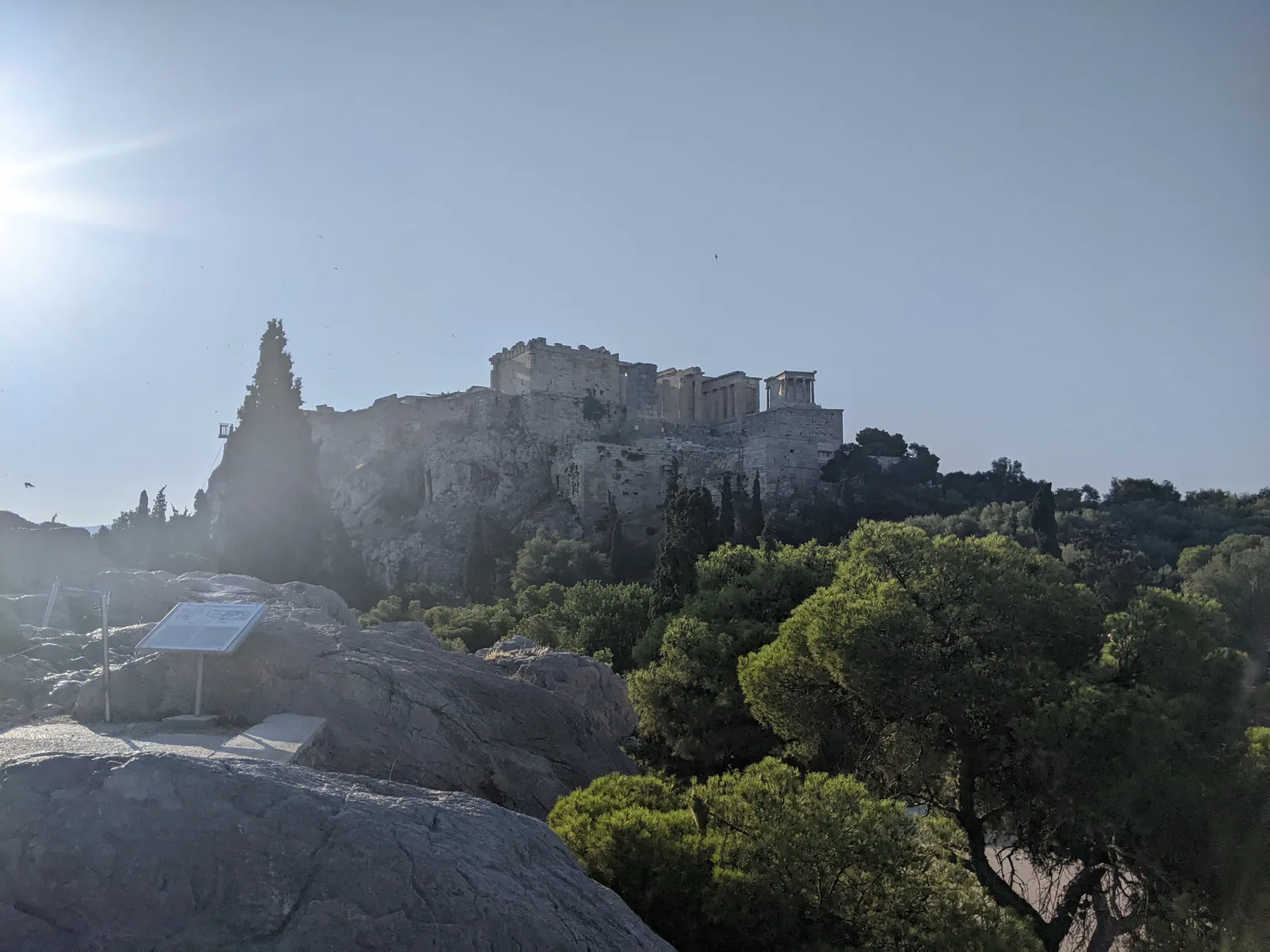 The Acropolis seen from Areopagus Hill, Athens, with the Parthenon backlit against a hazy sky