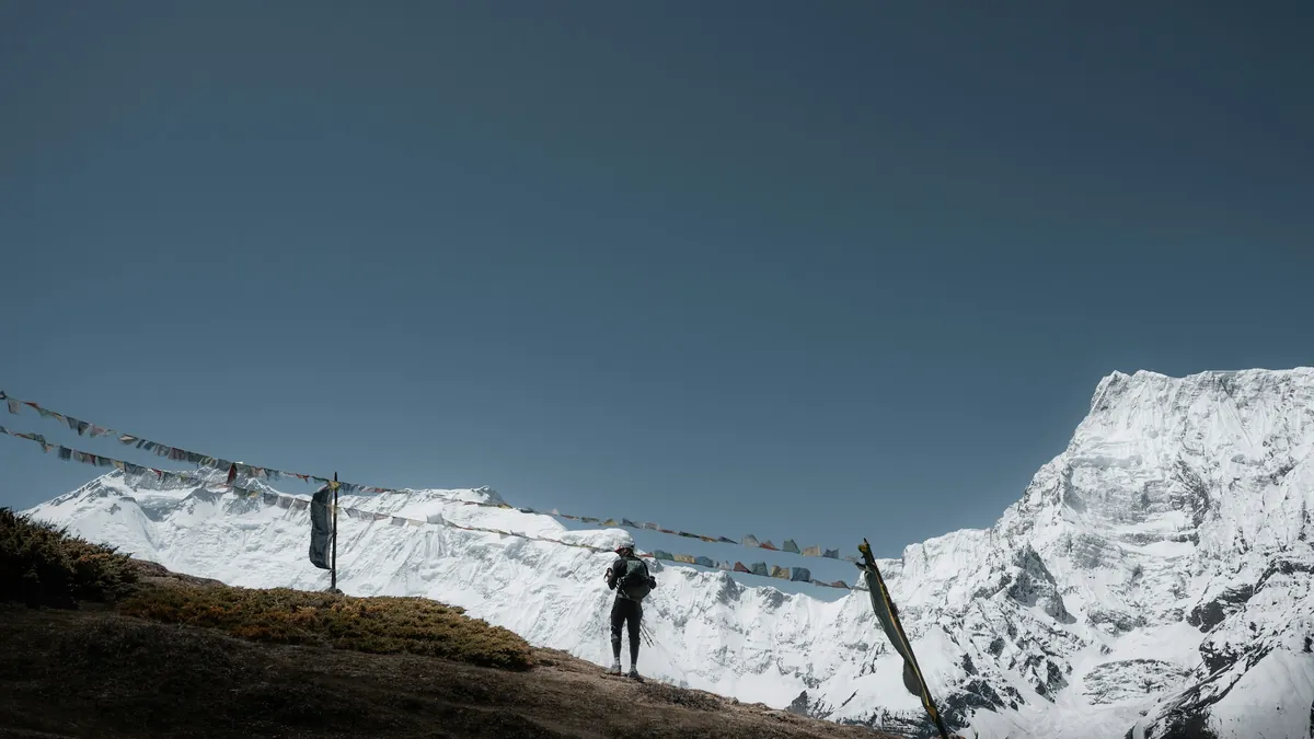 Trekkers walking towards snow peaks on the Annapurna Circuit in Nepal