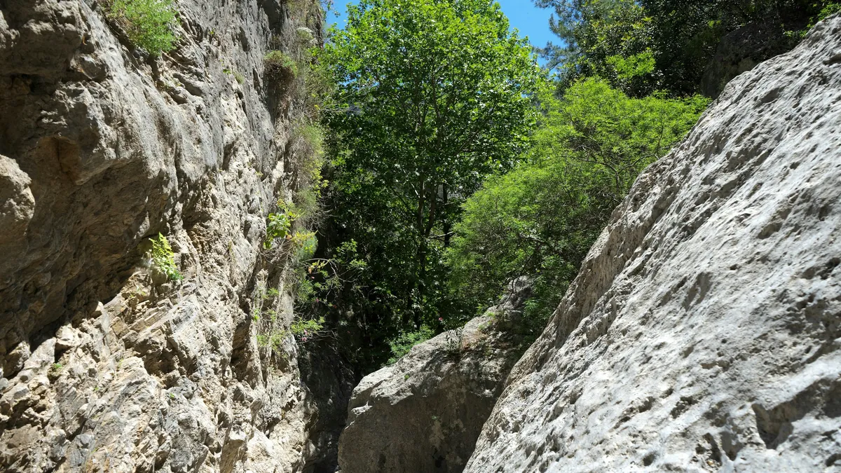 Trekkers descending through the narrow Samaria Gorge in Crete, Greece