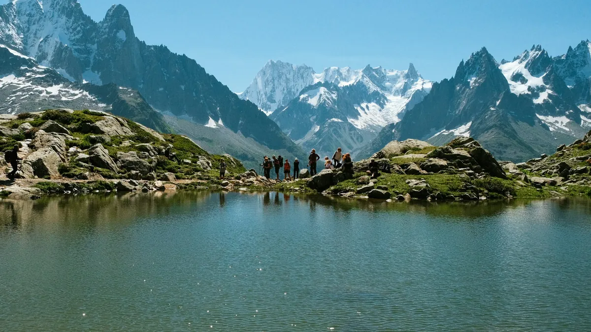 Hikers on the Tour du Mont Blanc with snow-capped Alps in the background