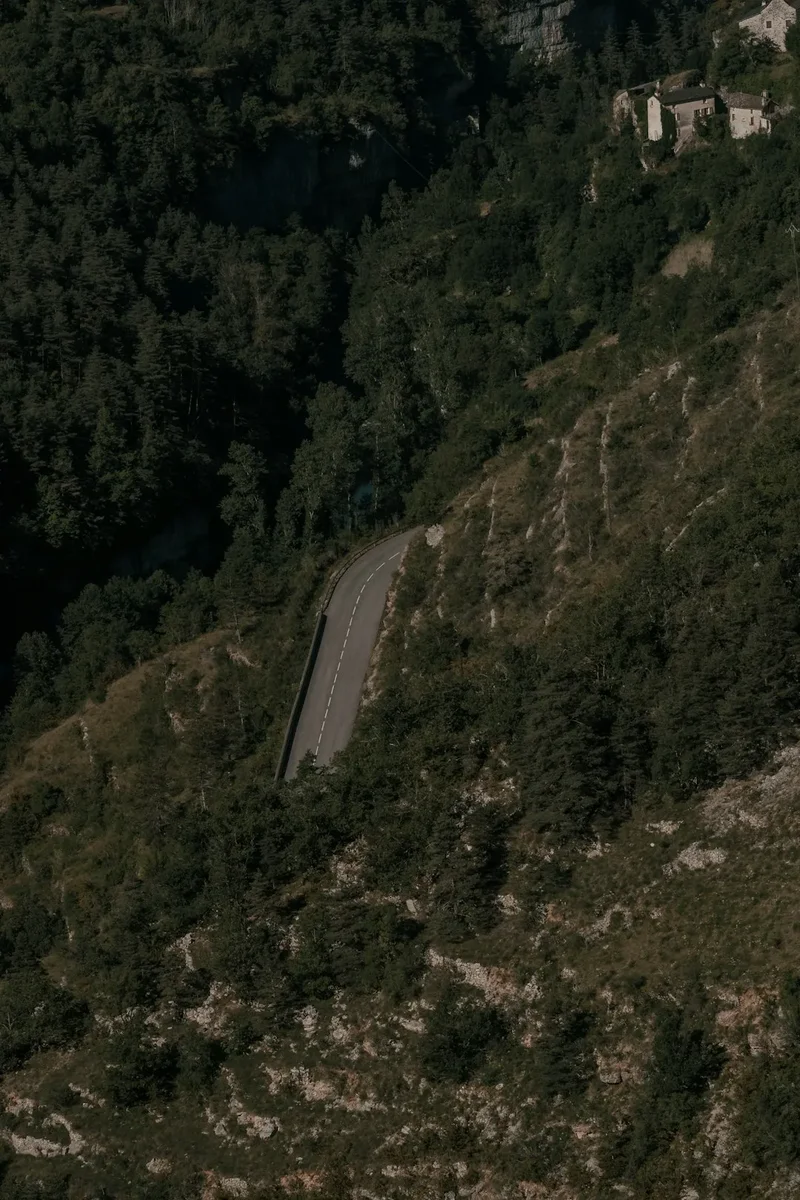 an aerial view of a winding road in the mountains