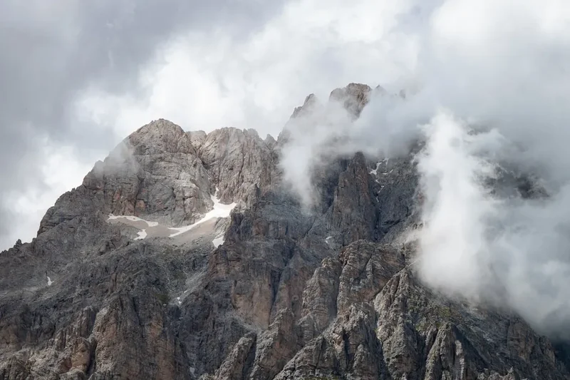 brown rocky mountain under white clouds during daytime