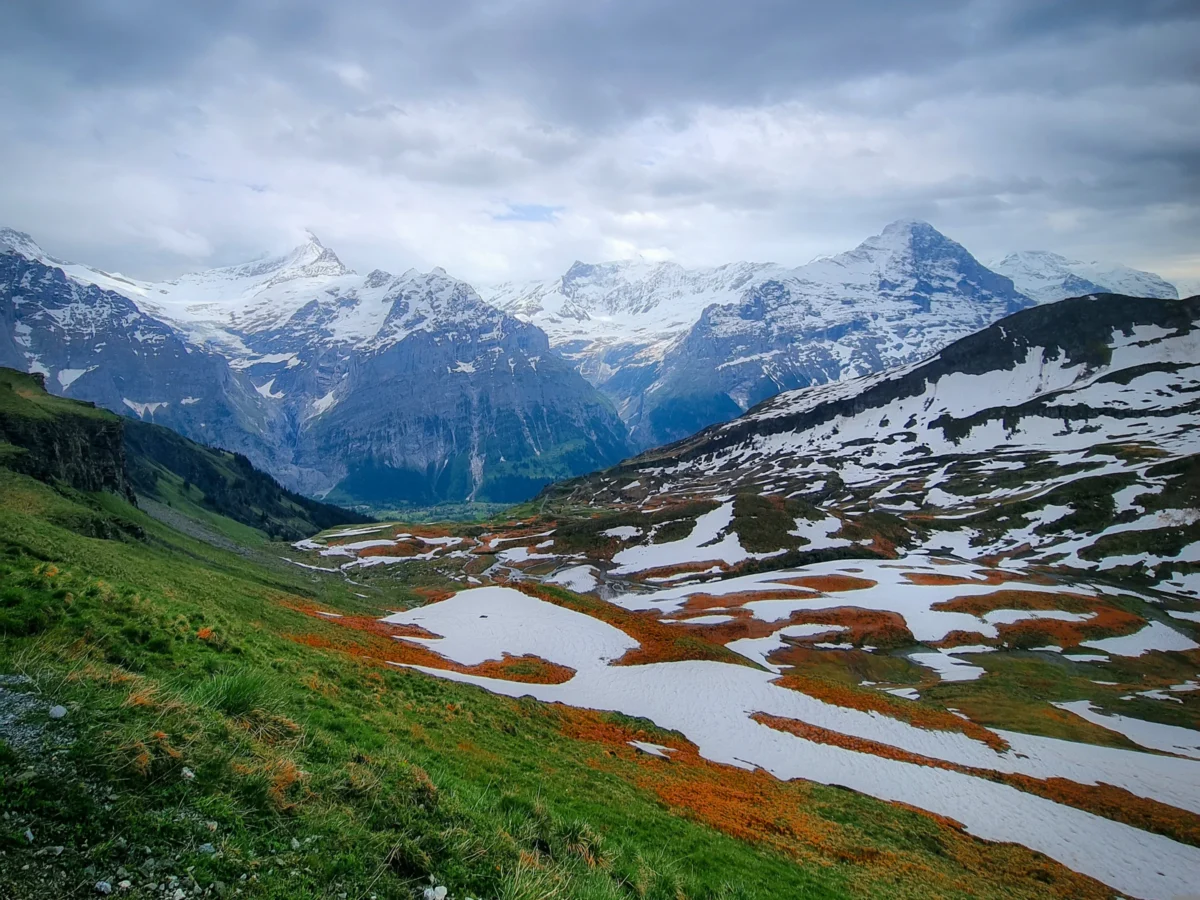 a snowy mountain range with a village in the foreground