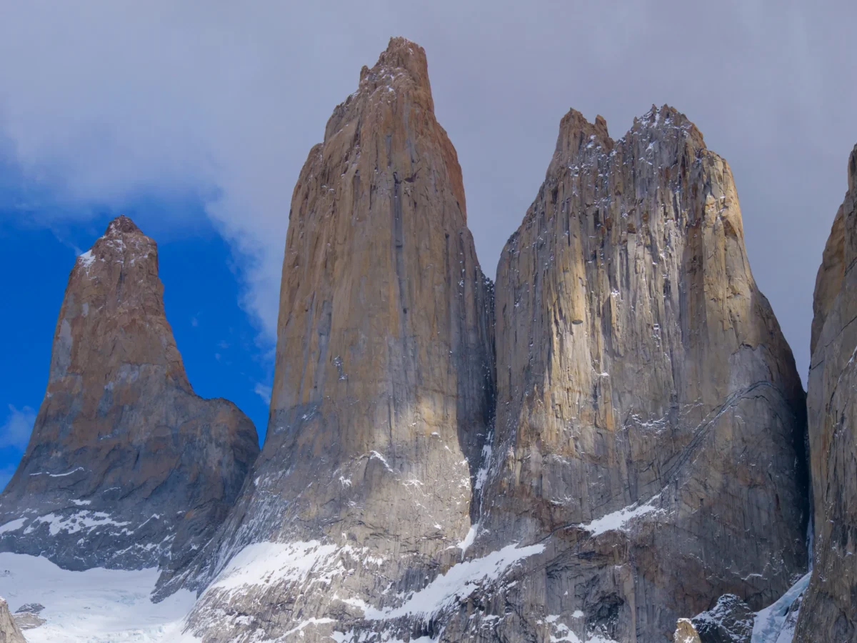 the mountains are covered in snow and clouds