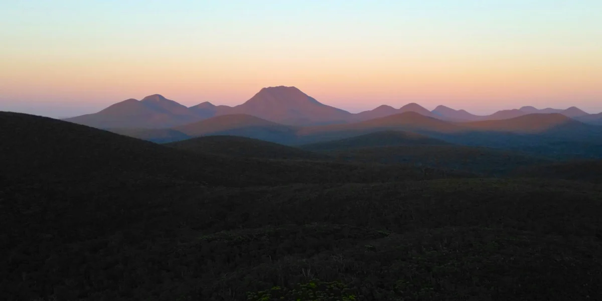 A view of a mountain range at sunset