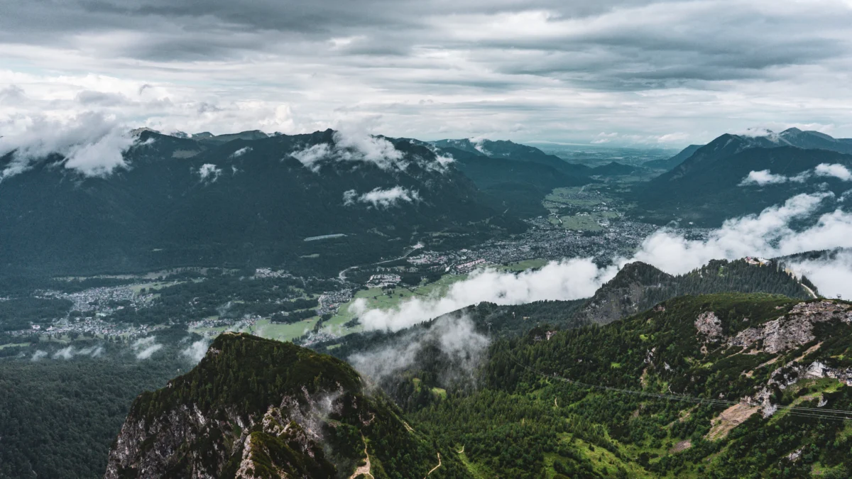 Mountains and valley scene with low clouds.