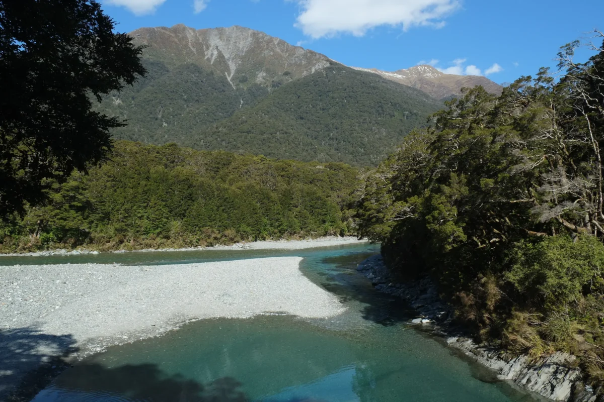 a body of water surrounded by rocks and a mountain