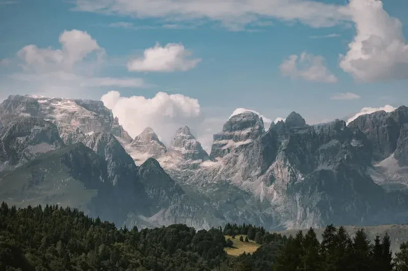 The mountains are covered in snow and clouds