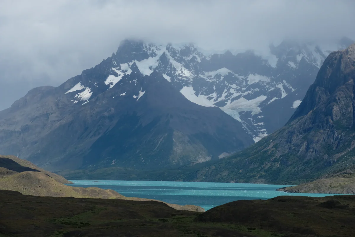 a mountain range with a body of water in the foreground