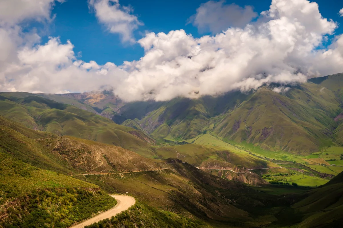green mountains under white clouds and blue sky during daytime
