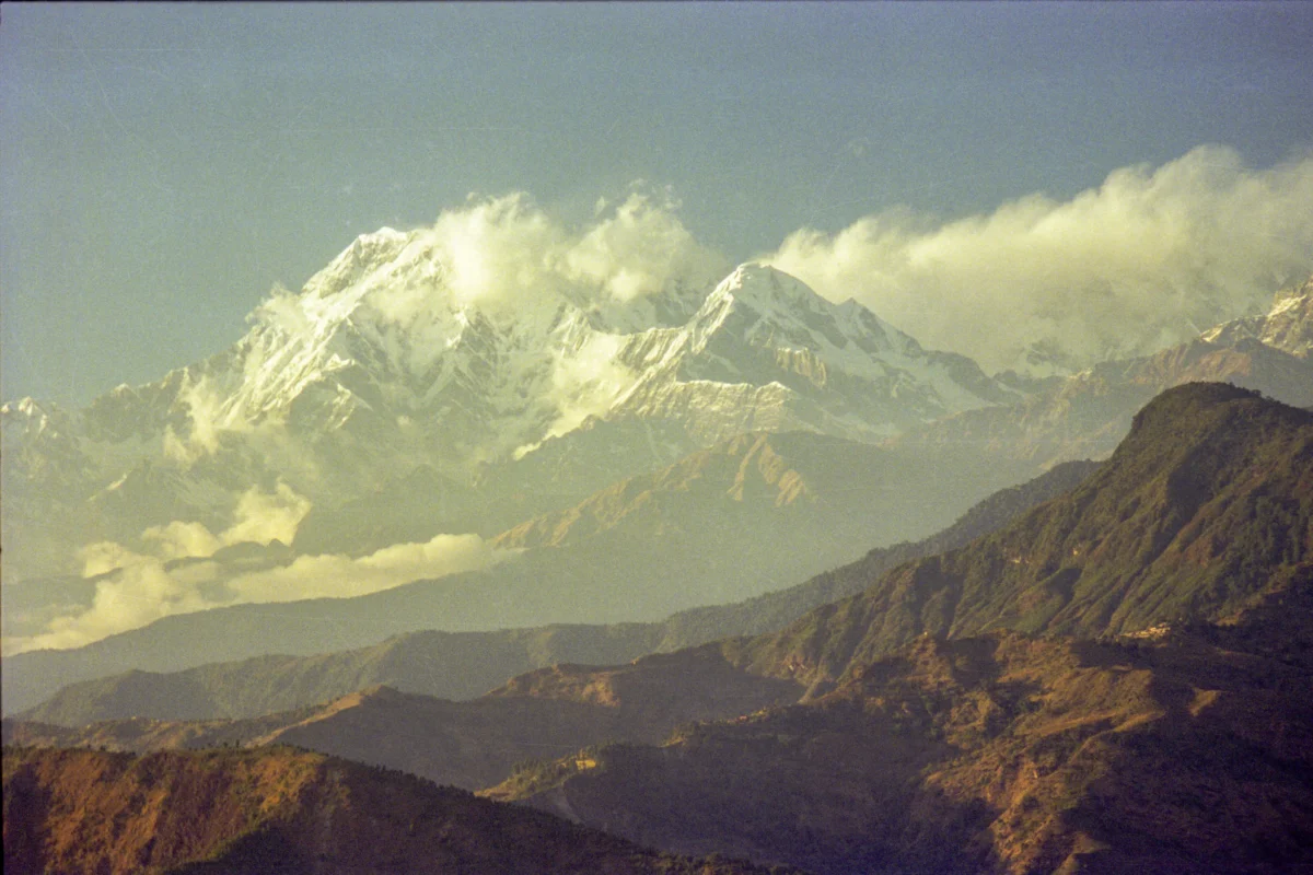 Snow-capped mountains under a hazy sky