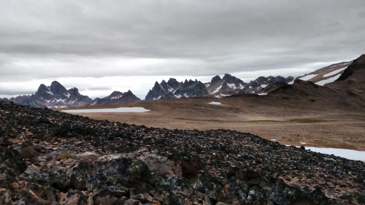 brown and green mountains under white clouds and blue sky during daytime