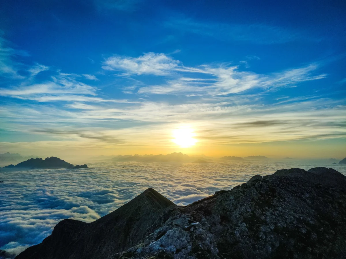 a very tall mountain with a sky in the background