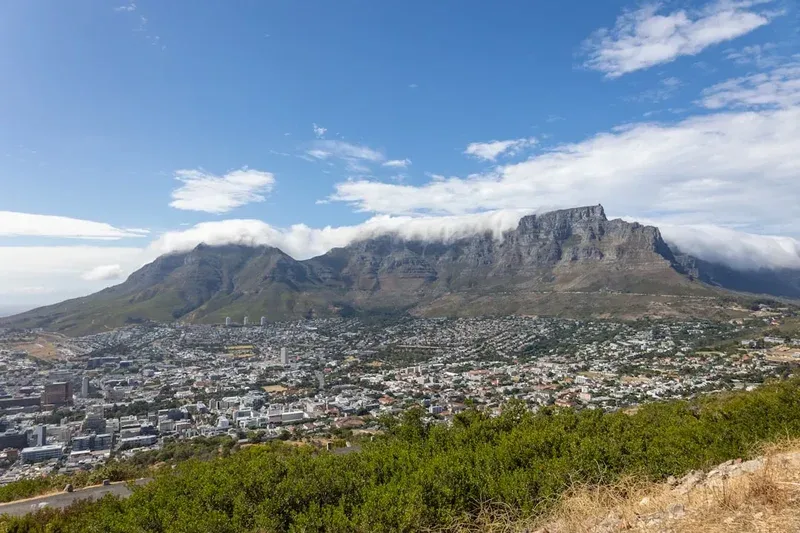 Table mountain overlooking cape town under a cloudy sky