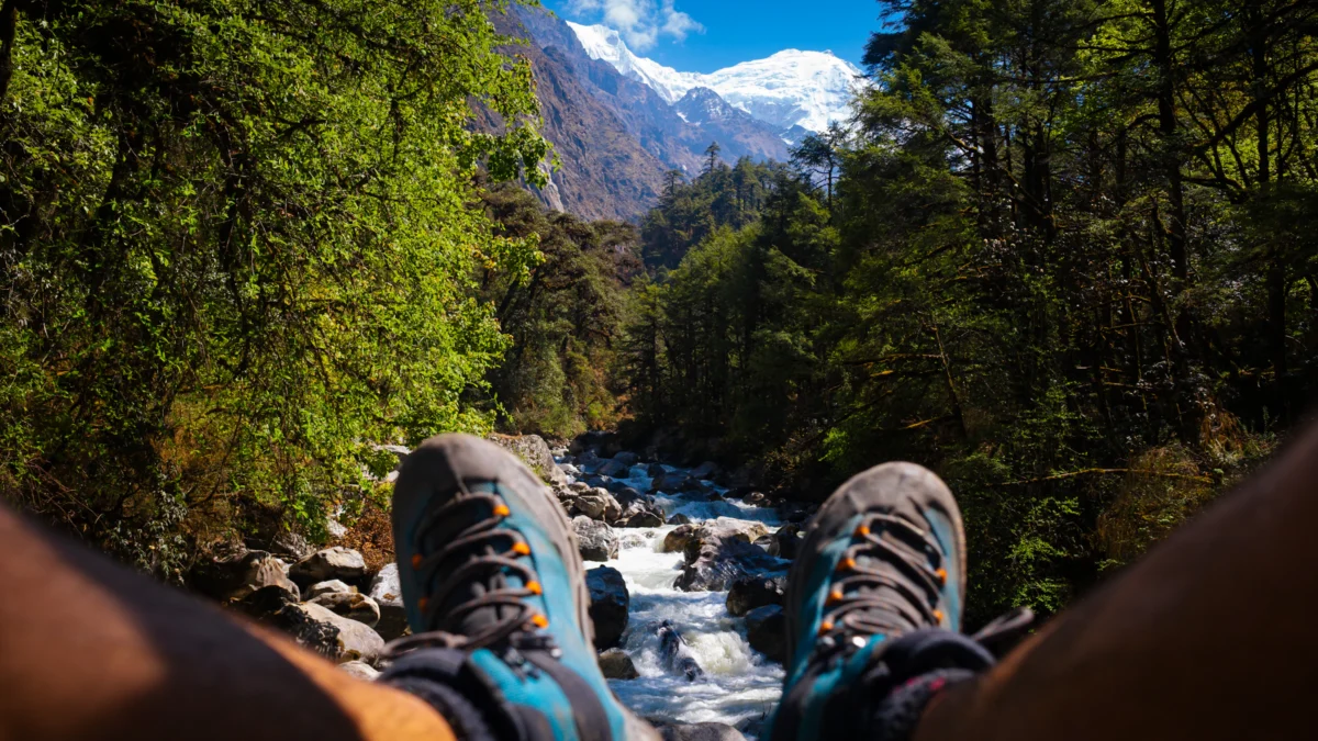 Feet resting, looking at a mountain and river.