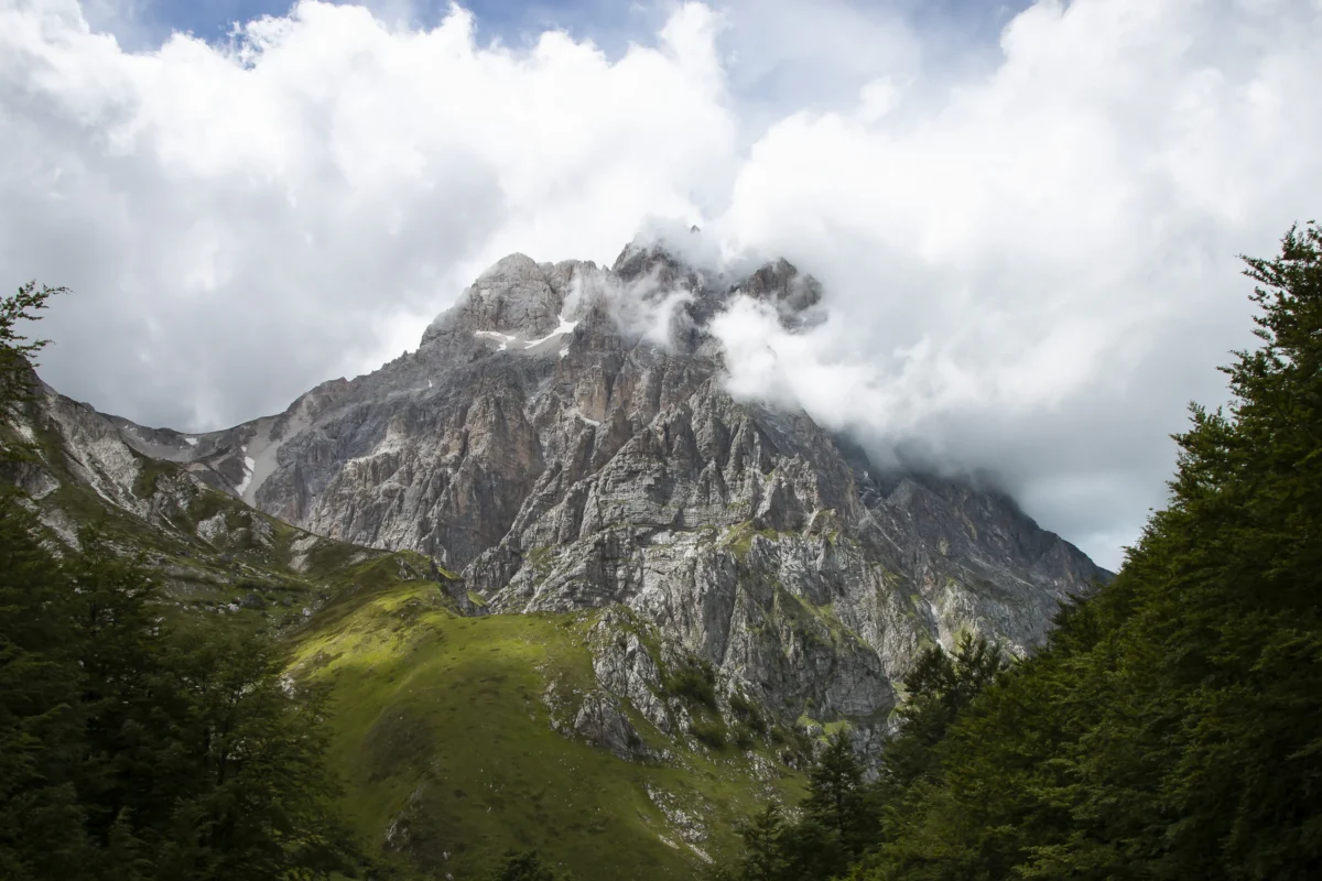 brown rocky mountain under white clouds during daytime