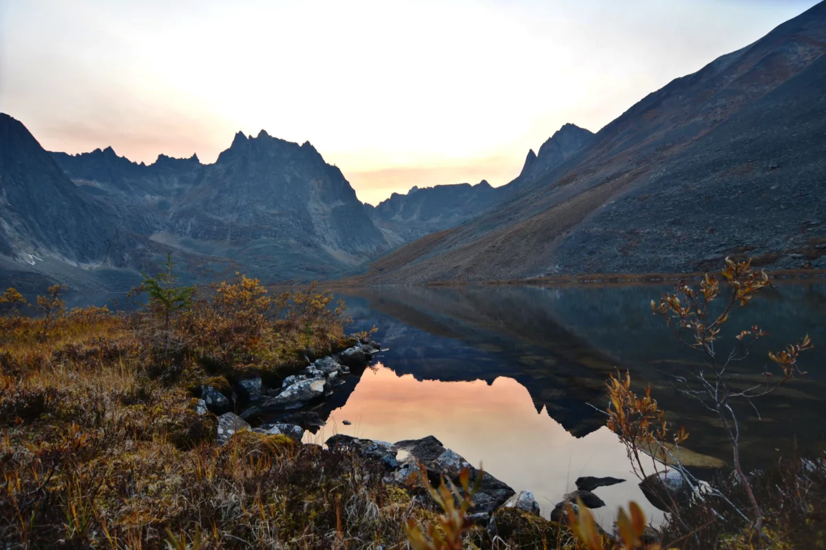 Misty mountains rise above two serene alpine lakes.
