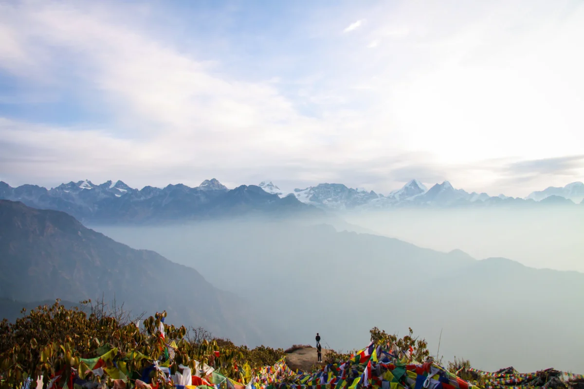 Mountain peaks stretch across a vast, misty landscape.