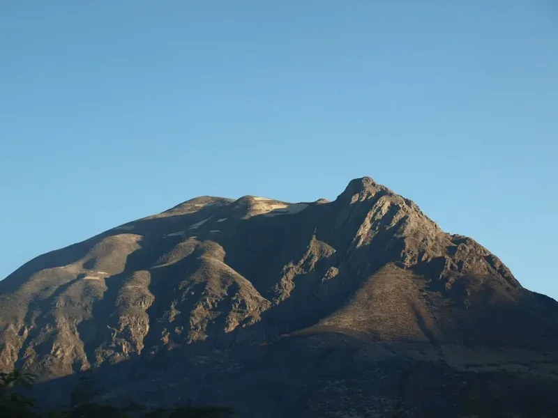 a very tall mountain with a clear blue sky