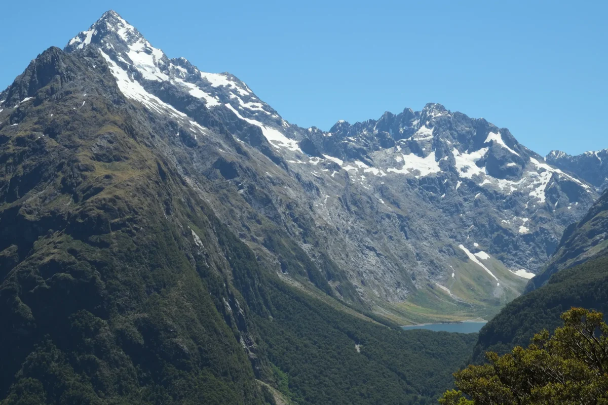 a view of a mountain range with a lake in the foreground
