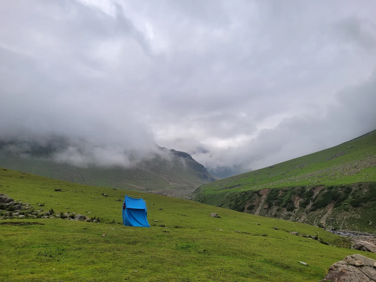 a tent on a grassy hill