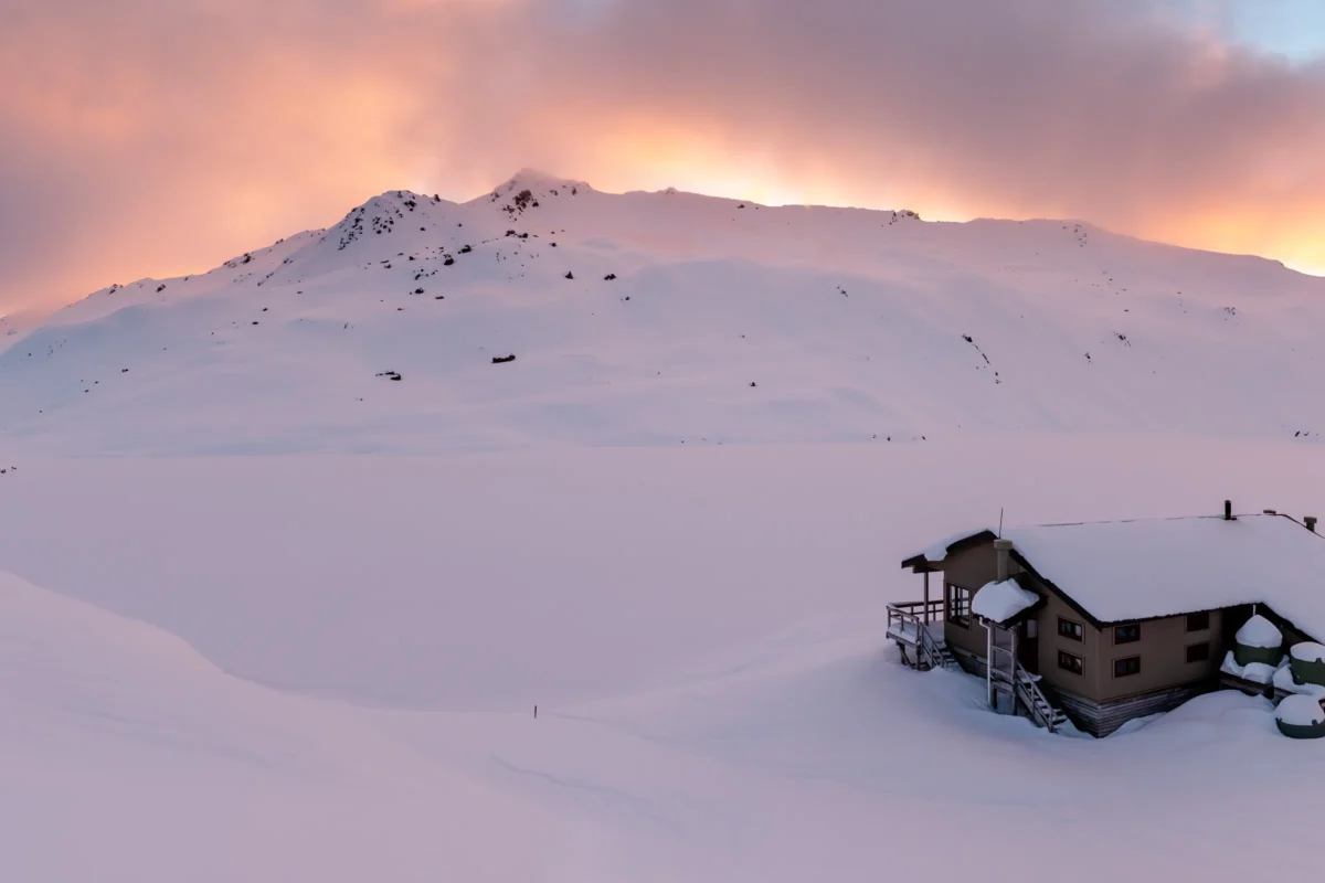 a mountain range with snow capped mountains in the distance