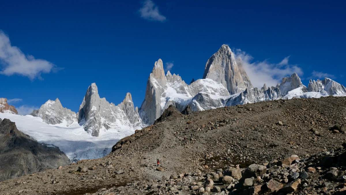 a field with a mountain range in the background