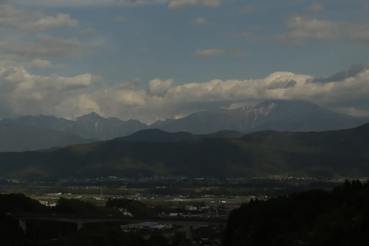 a view of a mountain range with a bridge in the foreground