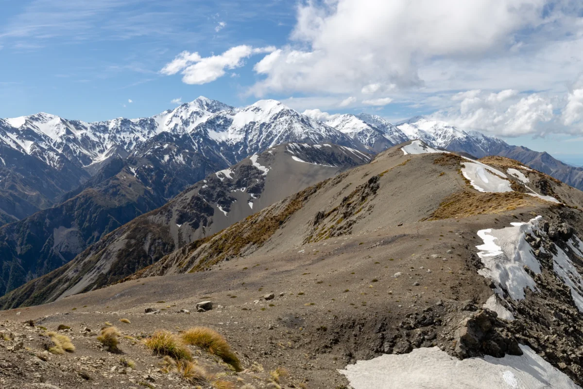 A view of a mountain range with snow on it