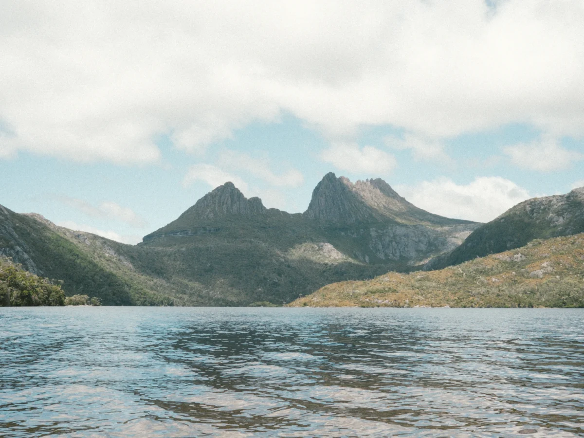 a body of water with mountains in the background
