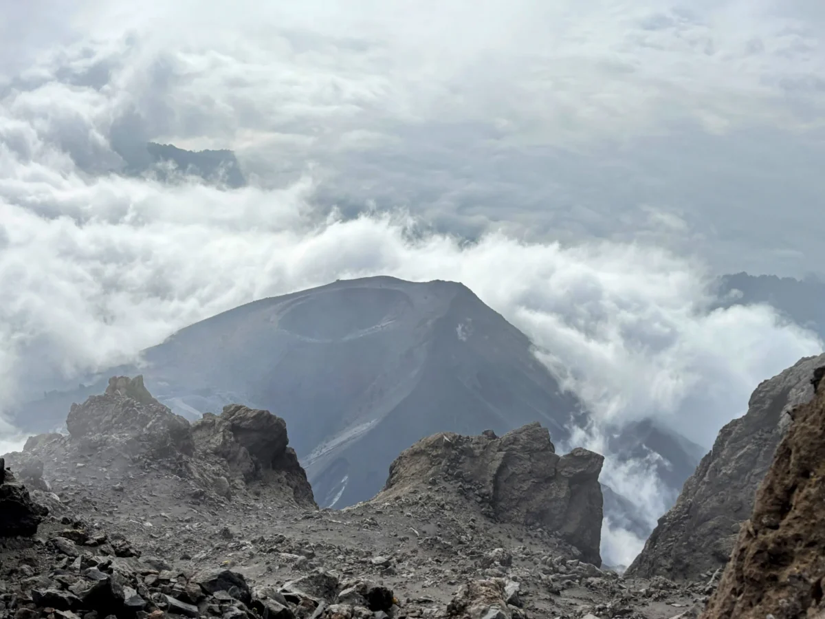 a view of a mountain range from the top of a hill