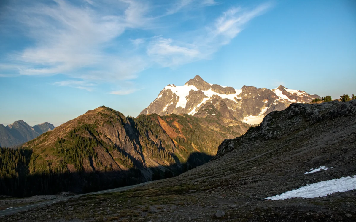 A view of a mountain range with snow on the ground