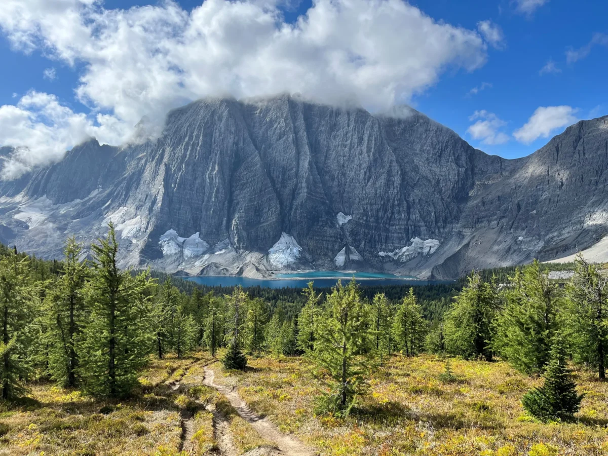 a view of a mountain range with a few clouds in the sky