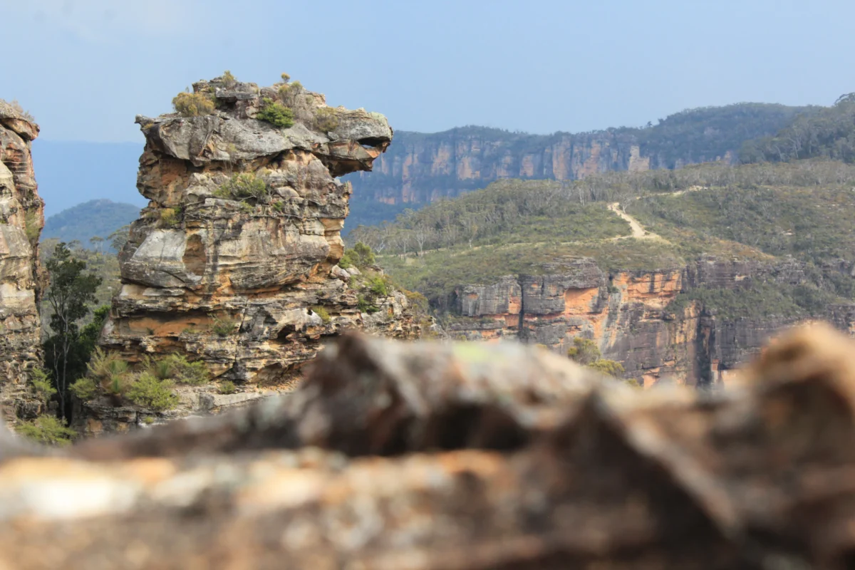 Rocky formations with distant mountains under clear sky