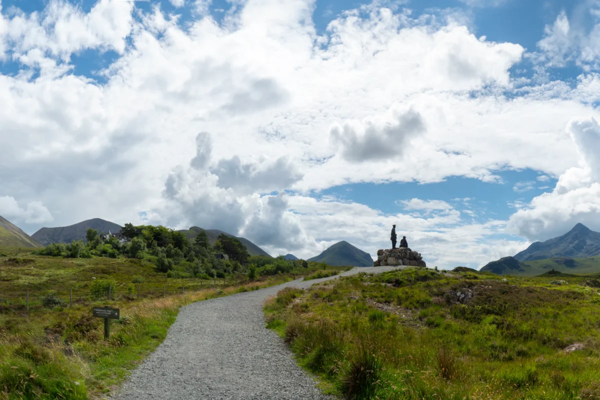 a scenic view of a winding road in the mountains