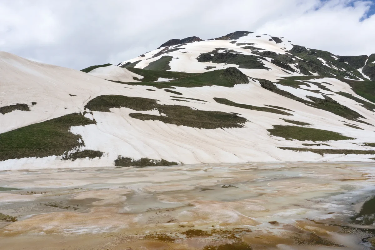 a body of water with hills in the back