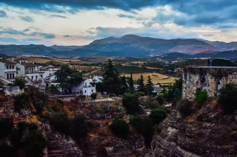 A scenic view of a town with mountains in the background