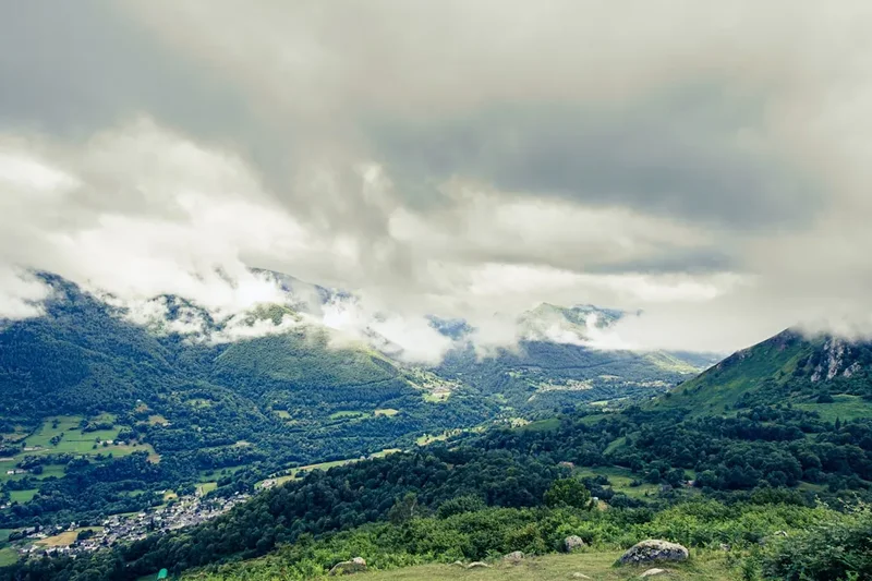 A scenic view of a valley with mountains in the background