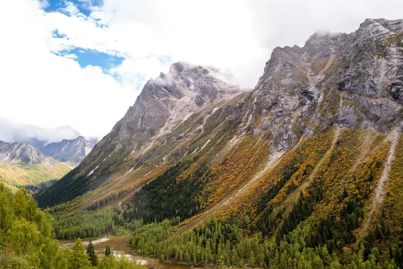 Majestic mountains with autumn foliage and a river