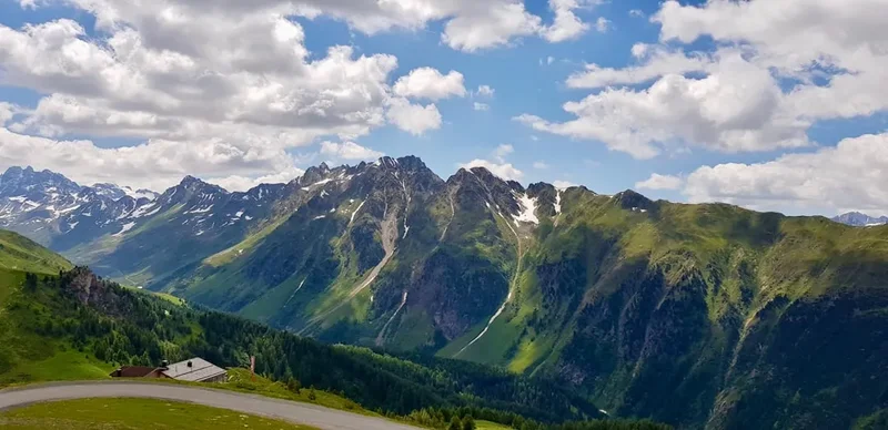 A scenic view of mountains and a road