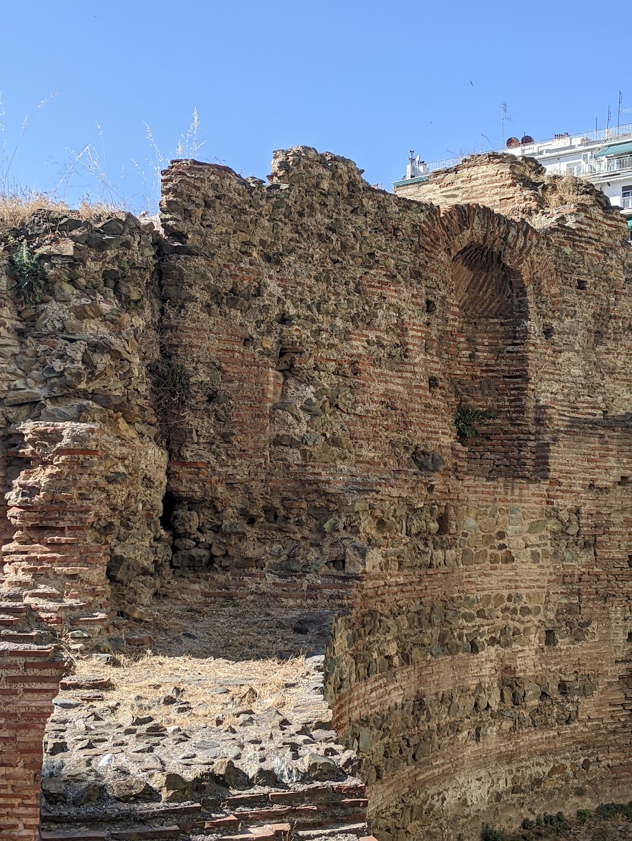 Detail of a ruined brick wall and niche at the Palace of Galerius against a blue sky, Thessaloniki