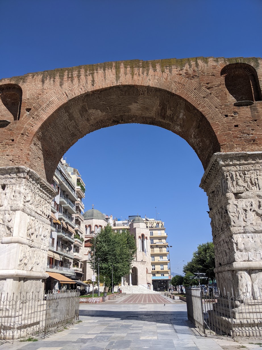 Looking through the arch of the Kamara to a Byzantine church and the living city beyond, Thessaloniki