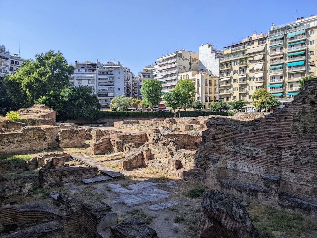 Excavated brick ruins of the Palace of Galerius sunk below street level, apartment blocks behind, Thessaloniki