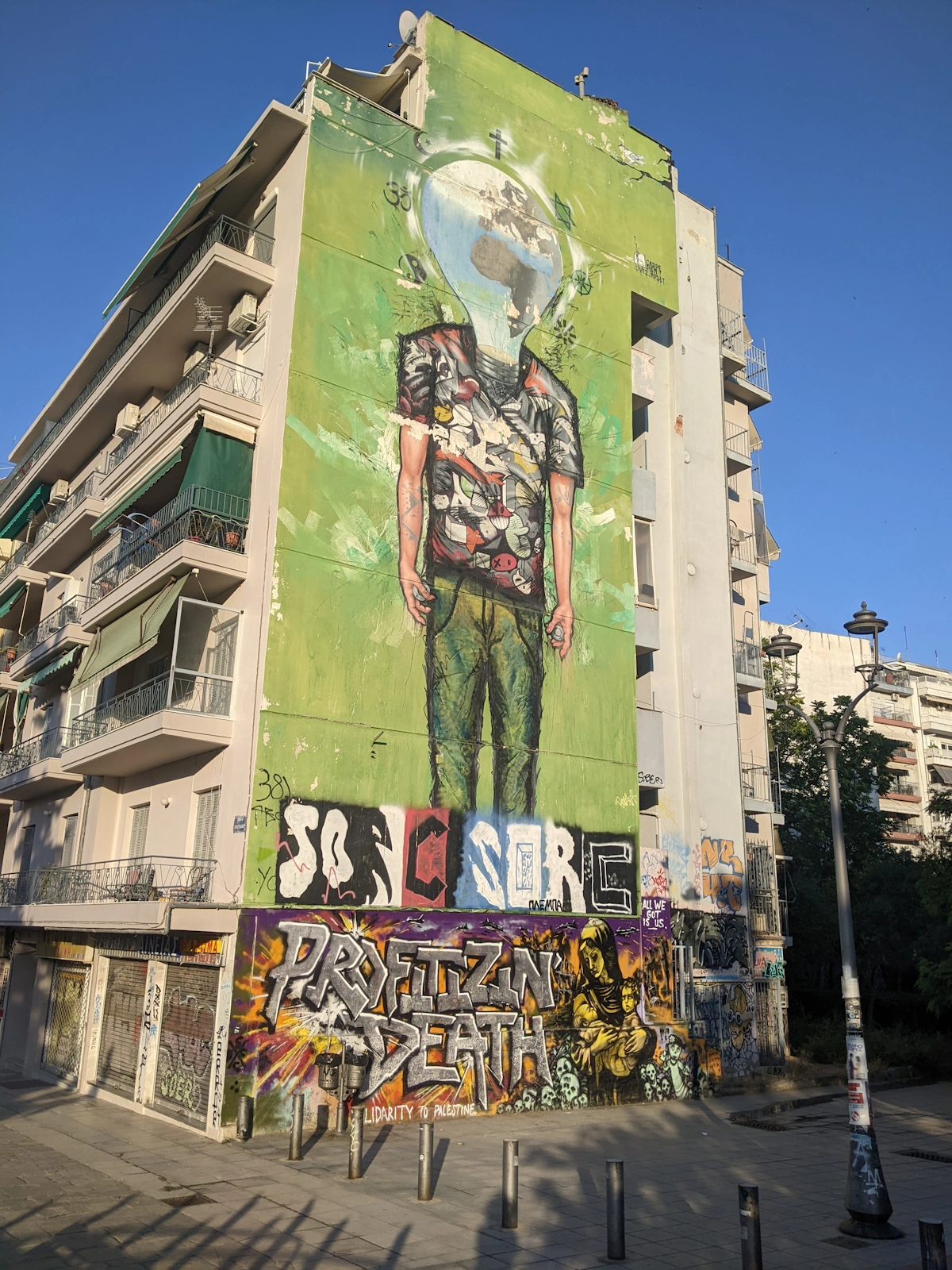 Multi-storey building mural of a figure with a lightbulb head by SORE, Thessaloniki
