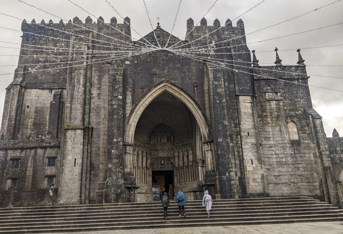 Historic stone pathway on the Camino de Santiago pilgrimage route winding through green countryside in northern Spain