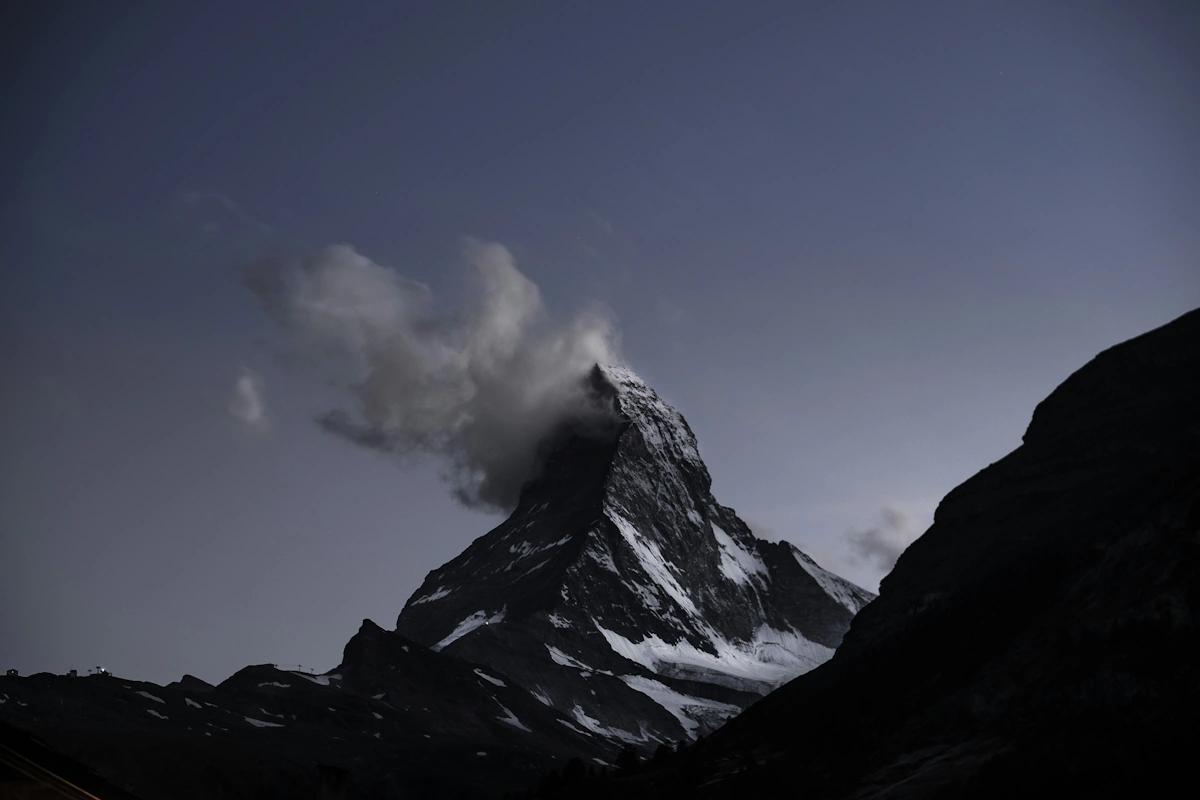 The iconic pyramid-shaped Matterhorn rising above alpine meadows and hiking trails in the Swiss Alps near Zermatt