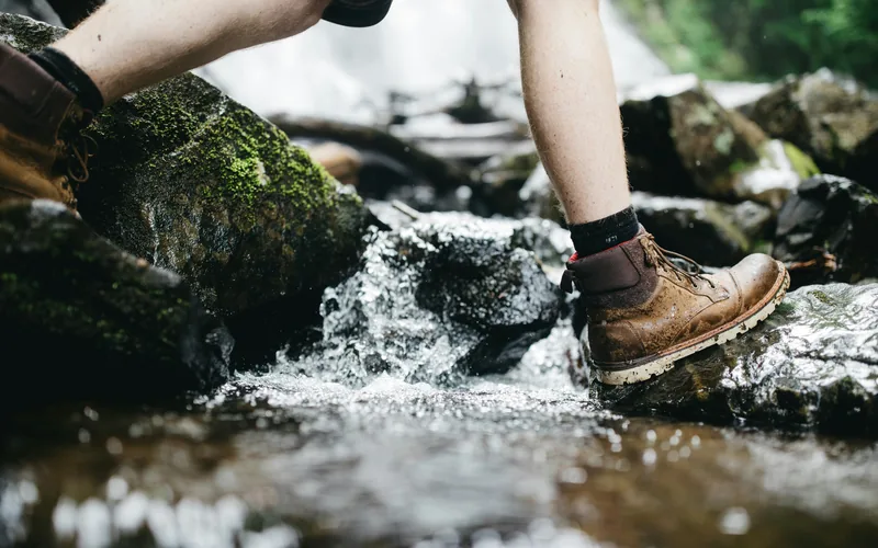 Merino and synthetic hiking socks laid out on a trail