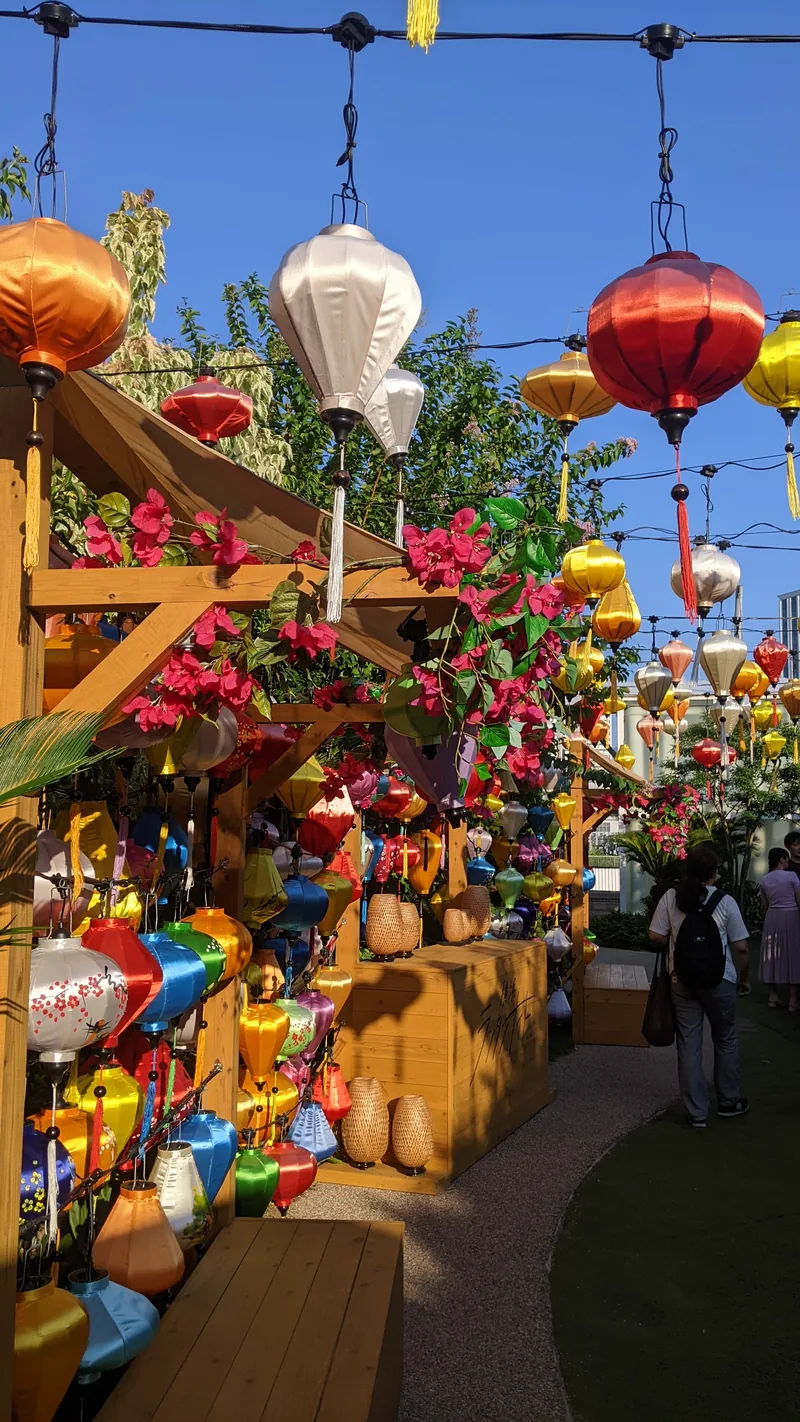 Market stall hung with bright lanterns in Yokohama Chinatown by day